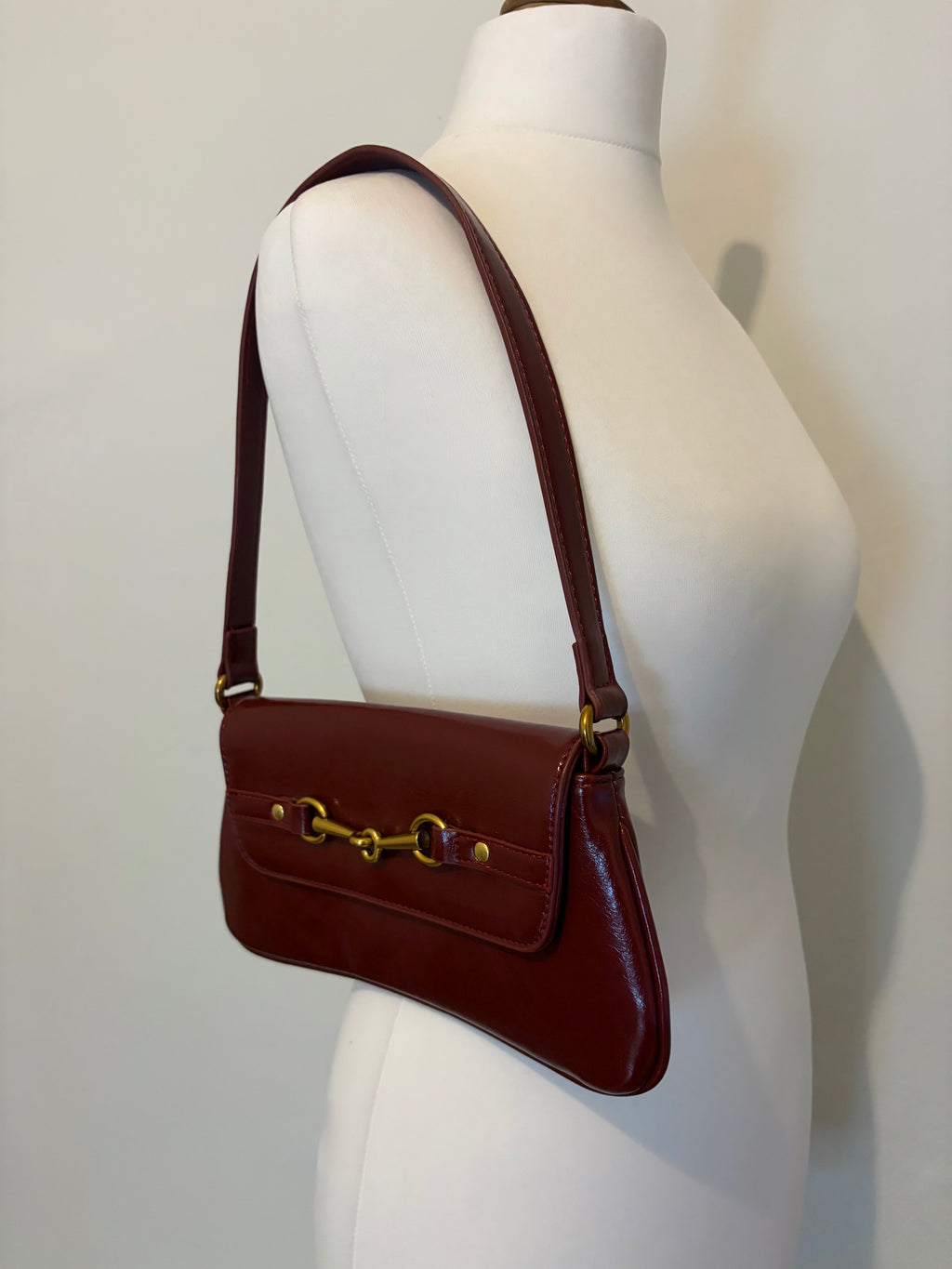 Red shoulder bag with metal hardware