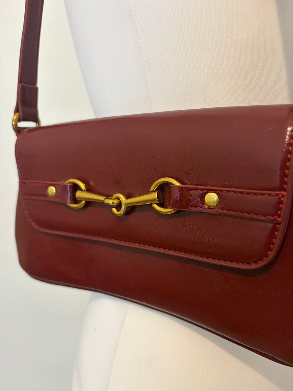 Red shoulder bag with metal hardware