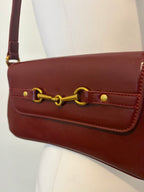 Red shoulder bag with metal hardware