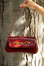 Red shoulder bag with metal hardware