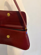 Red shoulder bag with metal hardware