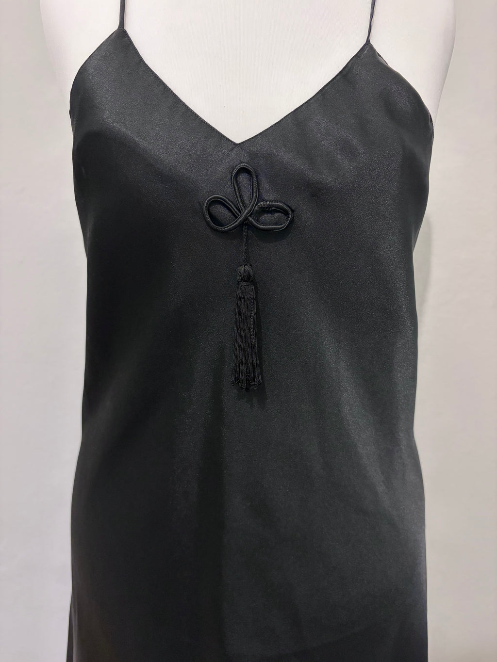 Black slip dress with tassel detail