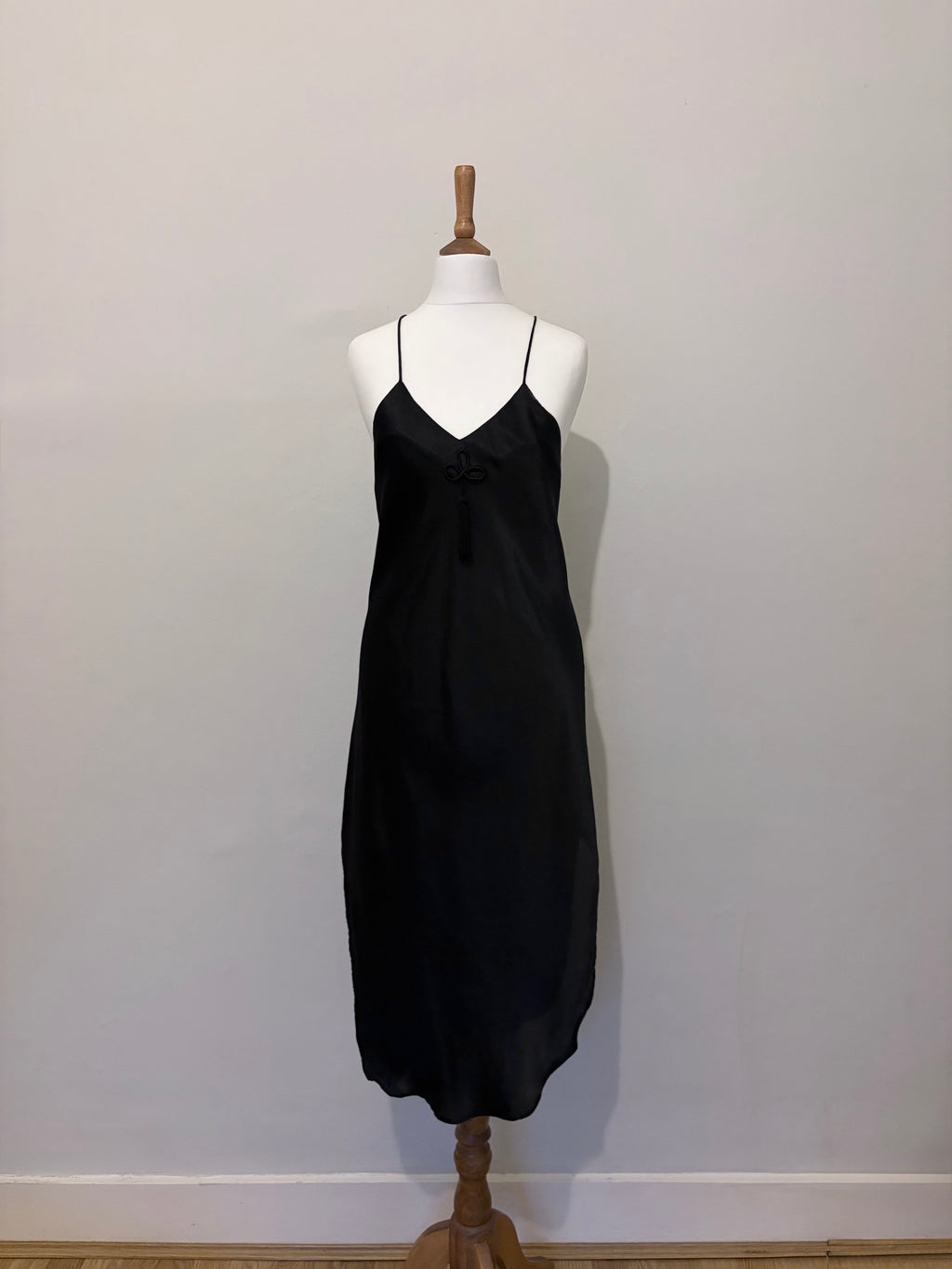 Black slip dress with tassel detail