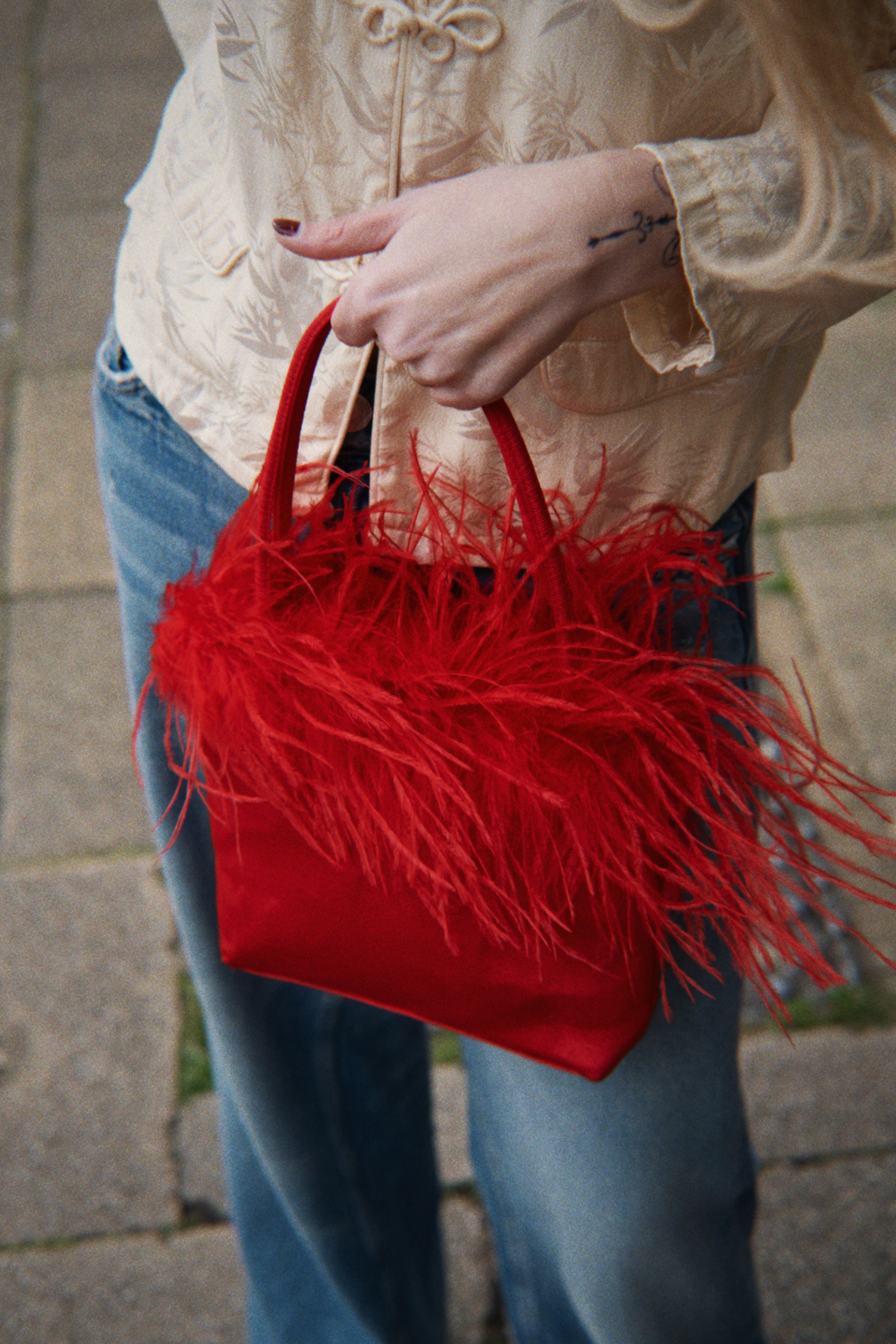 Red feather detail bag