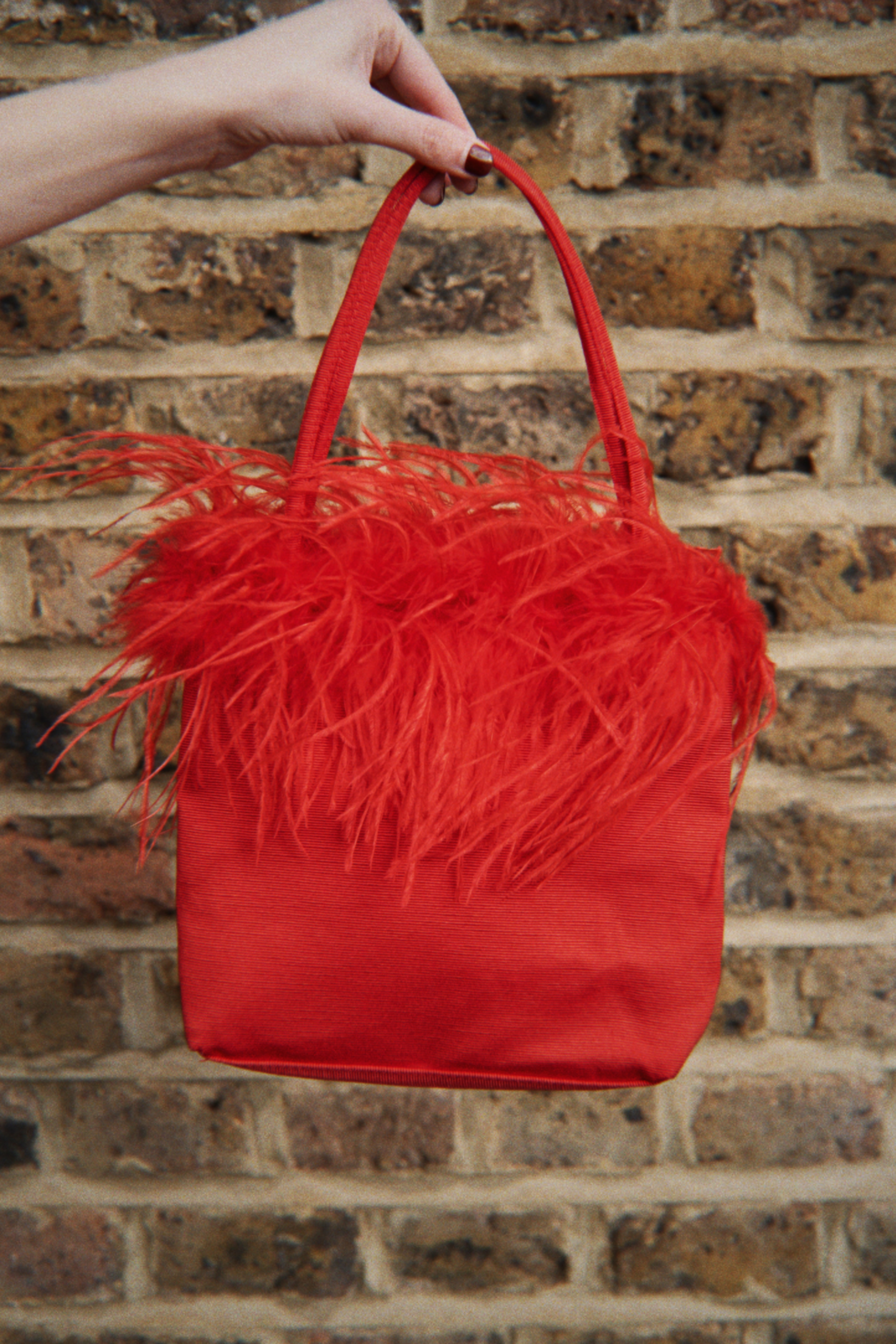 Red feather detail bag